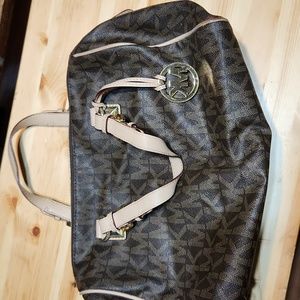 Michael kors purse brown and tan. Couple of red stains on inside liner.